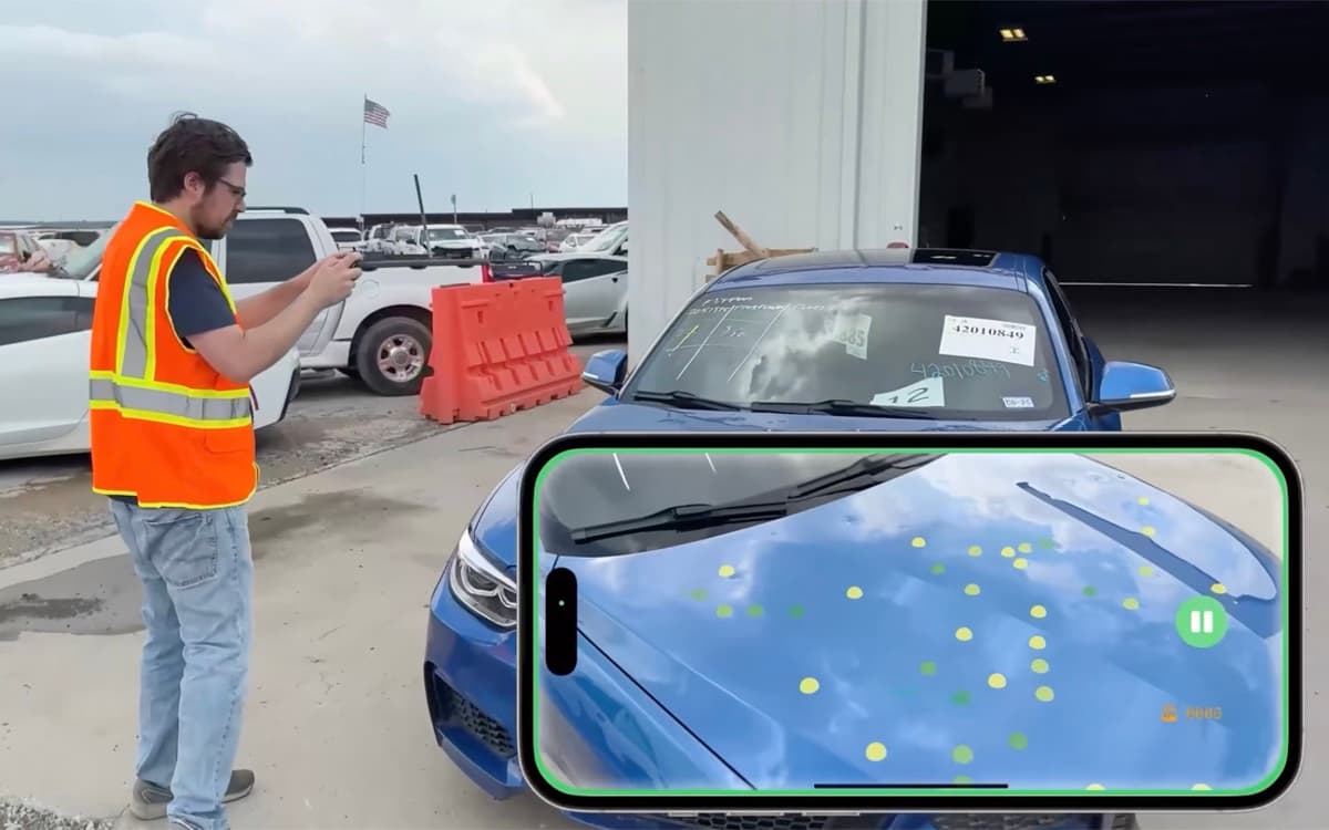 Inspector capturing a 3D scan of a blue car hood with dent points highlighted on a phone